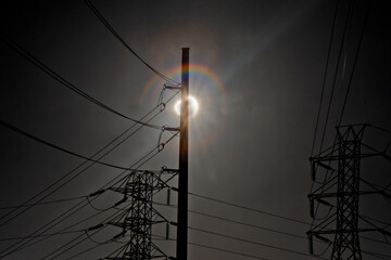 Sun and prism effect Silhouette power poles and electrical wires 