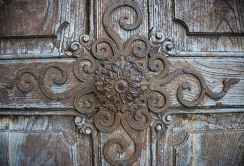 Beautiful old wooden door detail at the pilgrimage Church Maria Strassengel, a 14th century Gothic church in the town of Judendorf Strassengel near Graz, Steiermark region, Austria