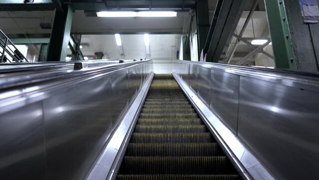 Riding Escalator in Subway Station in NYC. Automatic stairs moving