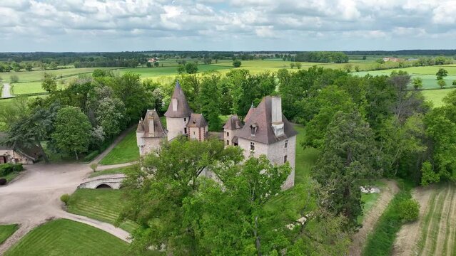 View of Chateau de Thoury in Saint-Pourain-sur-Besbre in Auvergne, feudal castle with fortified high curtain walls enclosing a courtyard, gate tower e