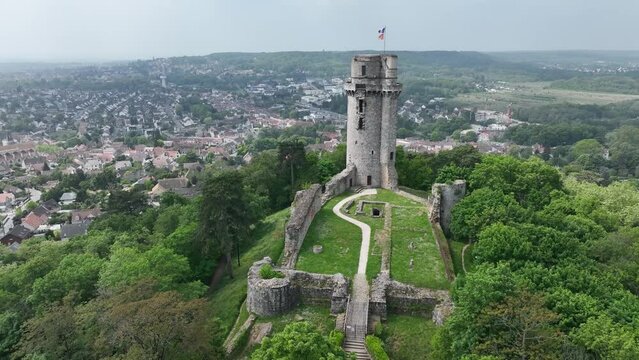 Aerial view of medieval ruined Montlh&eacute;ry castle controlling the Paris - Orleans road with prominent keep towering over the hill in Central France