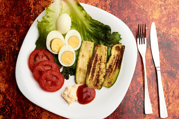 Boiled egg with combined vegetables such as pumpkin, Chinese lettuce, tomato to prepare them with ketchup and mayonnaise sauce