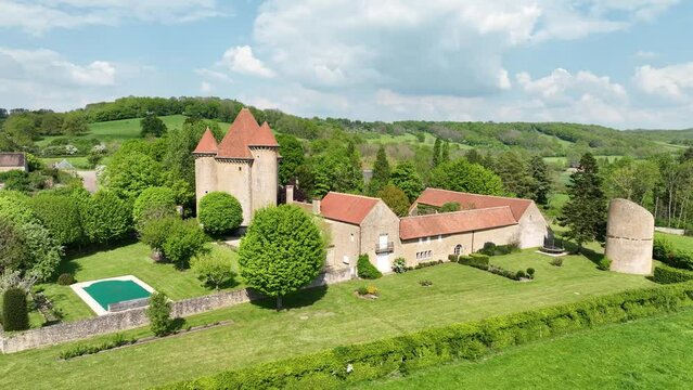 Aerial view of the Pancy castle in Angely Burgundy France with central keep protected by two circular towers, large outbuildings create a U-shaped wind around the courtyard standalone circular tower 