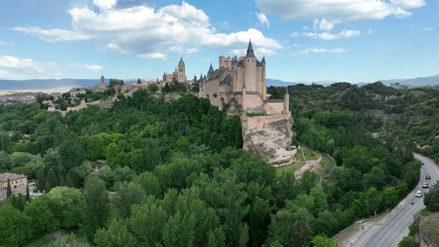 Aerial footage of Segovia old town with views of the Alcazar, Cathedral, medieval city walls
