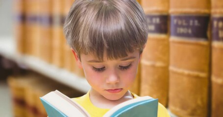Animation of caucasian boy reading book over library