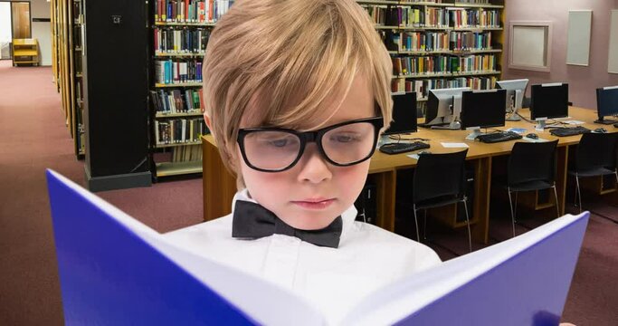 Animation of caucasian boy reading book over library