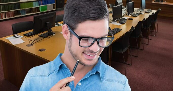Animation of happy caucasian man reading book over library - Powered by Adobe