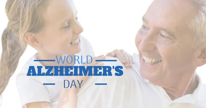 Animation of world alzheimer's day text over senior caucasian man with his granddaughter