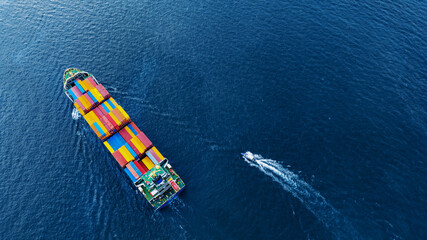 Aerial top view of cargo ship carrying container and running with Pilot Boat for export goods from cargo yard port to custom ocean concept technology transportation logistic trader blobal forward mast