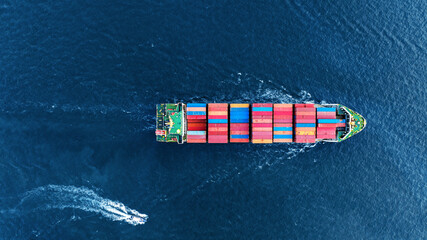 Aerial top view of cargo ship carrying container and running with Pilot Boat for export goods from...