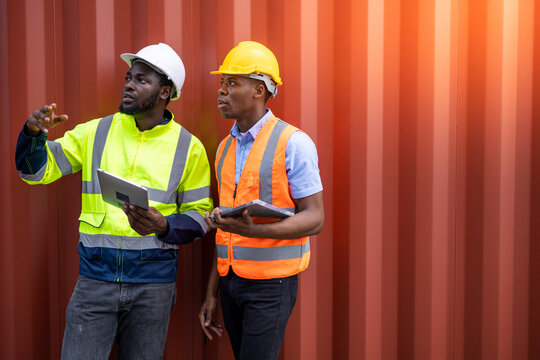 Container operator holding a tablet to do his routine inspection while working in container yards.