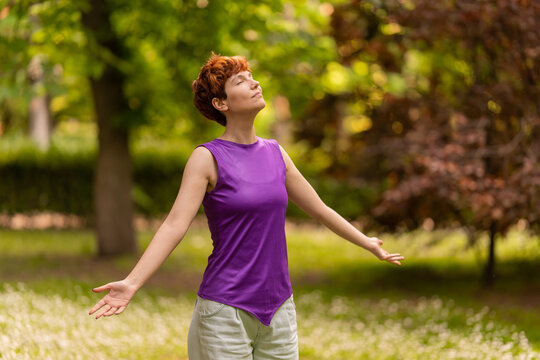 Androgynous Woman Enjoying Fresh Air In Park