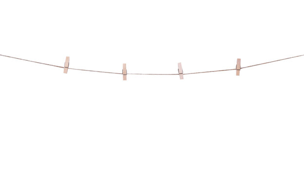 Four wood clothes pegs patterns hanging on brown string isolated on white background , clipping path