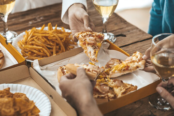 Hands people picking up pizza on a tray to eat, startup company parties, New Year's parties, company annual gatherings, alcoholic beverages. Company employee party catering ideas, pizza celebrations.