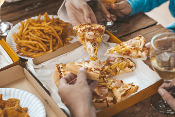 Hands people picking up pizza on a tray to eat, startup company parties, New Year's parties, company annual gatherings, alcoholic beverages. Company employee party catering ideas, pizza celebrations.
