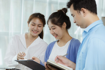 Fototapeta premium Groups Asian people chatting, business men and women meeting in a conference room, young business man running and running startups, young and energetic group running companies. Startup company concept