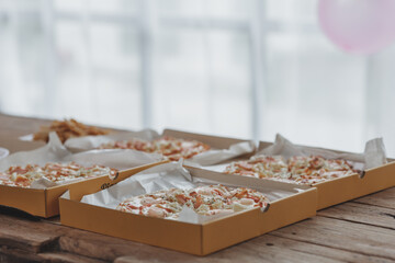 Many pizzas are placed on the table at the company, corporate office parties, startups, Italian food, pizza popular food that is easy to find and popular at parties. Party food ideas.
