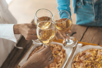 Group of young Asians clinking white wine glasses, startup company parties, New Year's parties, annual company parties, alcoholic beverages. Company employee party catering ideas, celebrations.