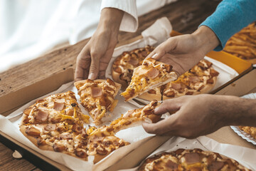 Hands people picking up pizza on a tray to eat, startup company parties, New Year's parties, company annual gatherings, alcoholic beverages. Company employee party catering ideas, pizza celebrations.