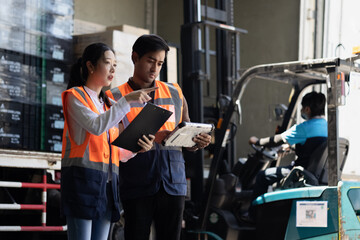 Warehouse worker and manager checks stock and inventory with digital tablet computer in the retail...