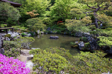 Fototapeta na wymiar View of pond, trees, flowers and plants at the Japanese zen garden of Ginkakuji Temple in Kyoto, Japan. No people.
