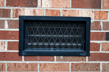 variegated brick wall with air vent, diamond grating