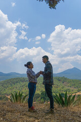 Fototapeta na wymiar Couple on a date on the mountains days before their weeding