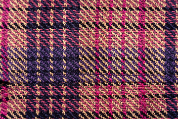 Plaid woven knit pink, purple, yellow and black textile bg texture