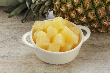 Marinated pineapple slices in the bowl