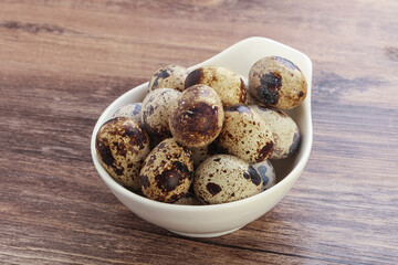 Raw quail eggs heap in the bowl