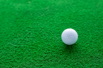 Golf ball on green grass of course close-up view