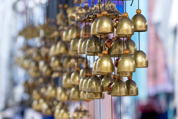 Small Brass bells hanging. Souvenir in Luang Prabang Night market, Laos.