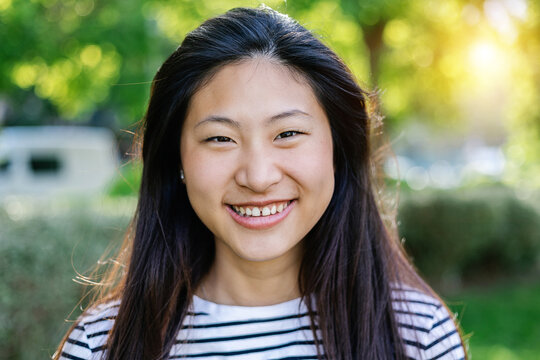 Portrait of young asian woman smiling at camera outdoor - Happy asian people concept