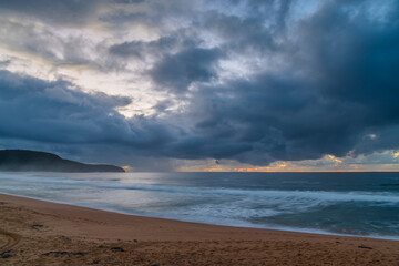 Overcast sunrise seascape with rain clouds