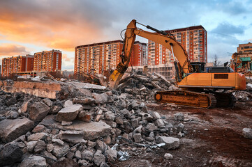 Fototapeta premium Excavator with crusher presses pile of reinforced cement