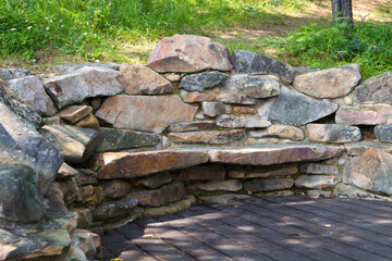 Bench made of stones for the rest of hikers in the mountains.