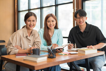 Education concept, Female tutor and students smiling and looking on camera while study tutorial