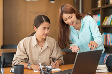 Education concept, Teenage girl pointing on laptop to asking question tutor while study tutorial
