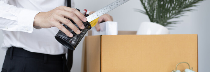 Put the work equipment in the office in a large brown box, Businessmen are keeping work documents...