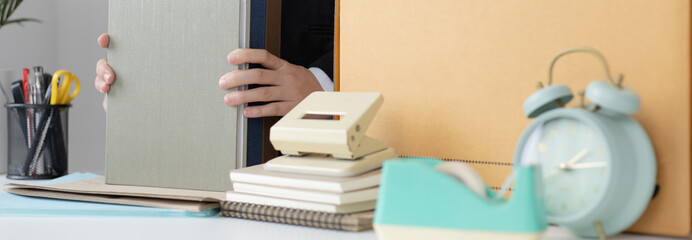 Put the work equipment in the office in a large brown box, Businessmen are keeping work documents...