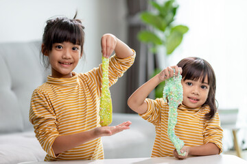 Kid play with handgum. Slime in children hands.