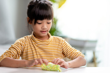 Kid play with handgum. Slime in children hands.