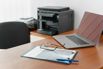 Working table of doctor therapist with laptop and medical documents ready for appointment