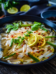 Pho soup - Vietnamese soup on wooden table