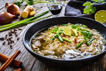 Pho soup - Vietnamese soup on wooden table