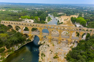 Papier Peint photo autocollant Pont du Gard pont du gard, famous bridge in france. The aerial view of the Pont du Gard, an ancient tri-level Roman aqueduct bridge in France.  Drone Aerial Roman Aquaduct Pont du Gard ruins. 
