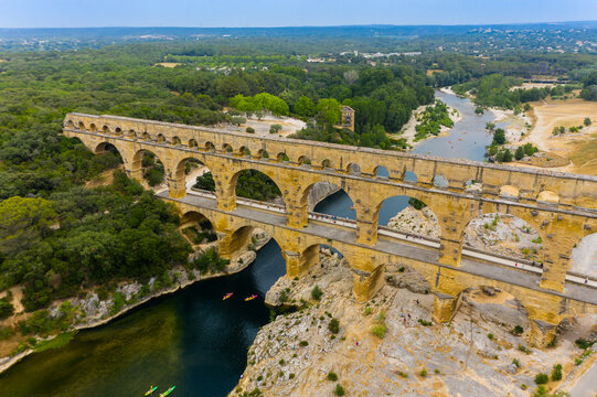 pont du gard, famous bridge in france. The aerial view of the Pont du Gard, an ancient tri-level Roman aqueduct bridge in France. Drone Aerial Roman Aquaduct Pont du Gard ruins. © Strikernia