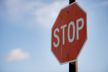 Stop sign with clouds in the background