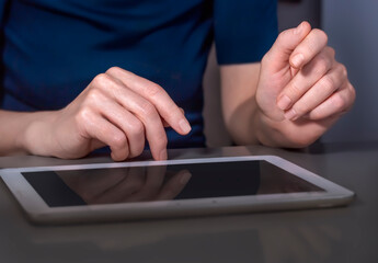 The hands of a businesswoman with a tablet