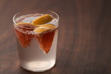 Grapefruit lemonade in tumbler glass on wood table